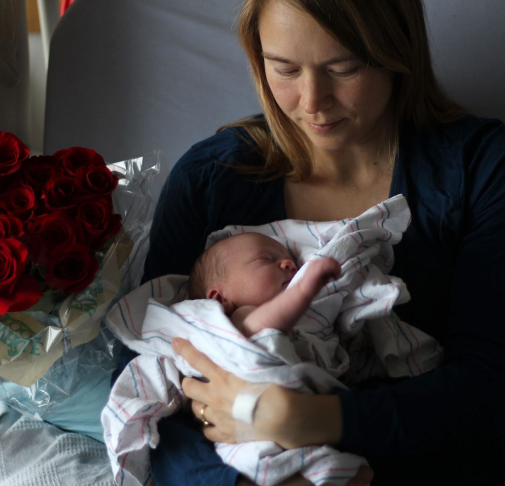 Newborn baby and mom reflecting in the hospital.